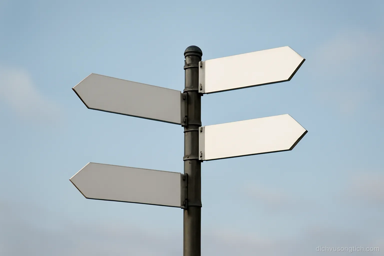 a signpost with several arms pointing in different directions against a plain sky