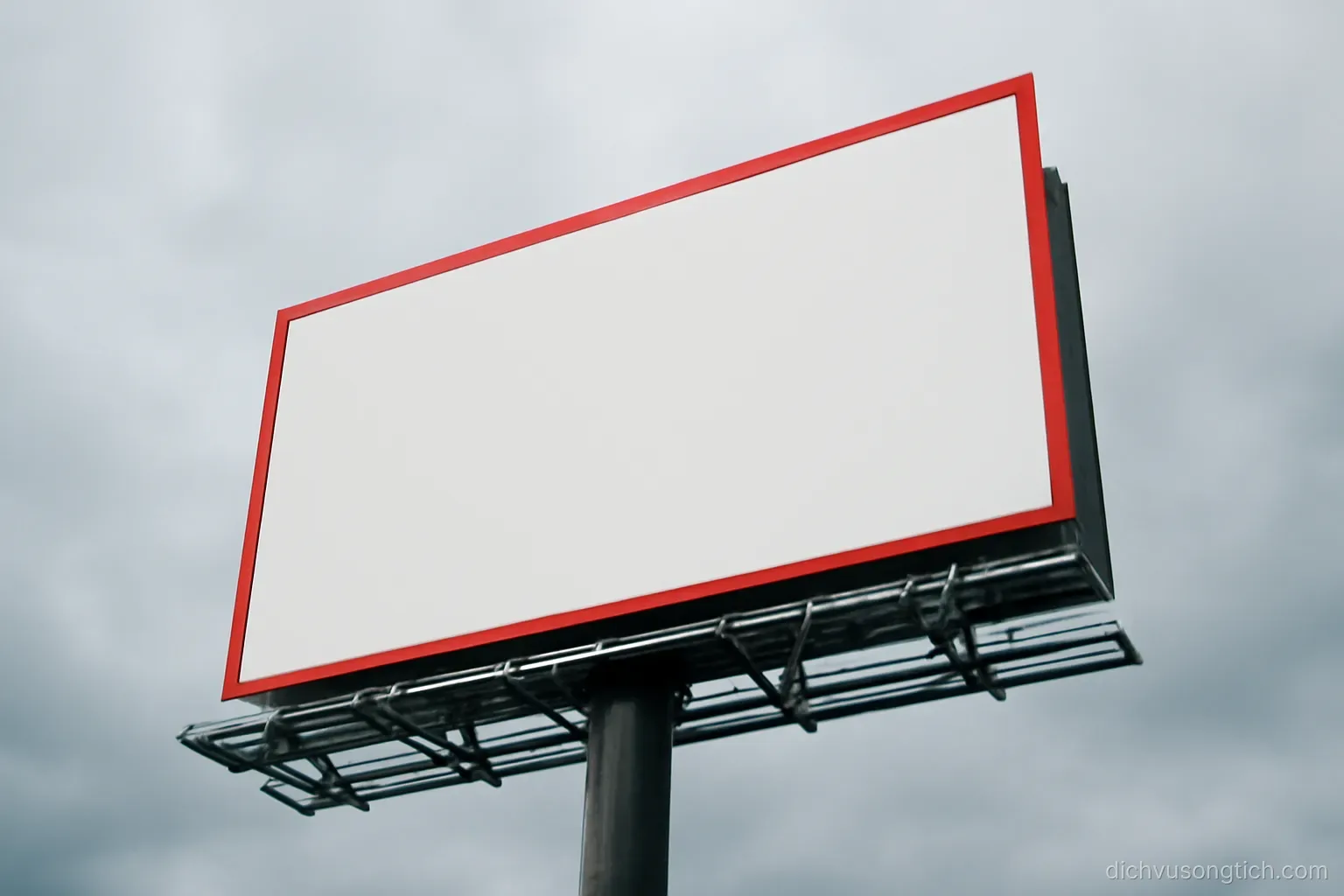 a bright advertising banner with bold lettering seen from below against an overcast sky